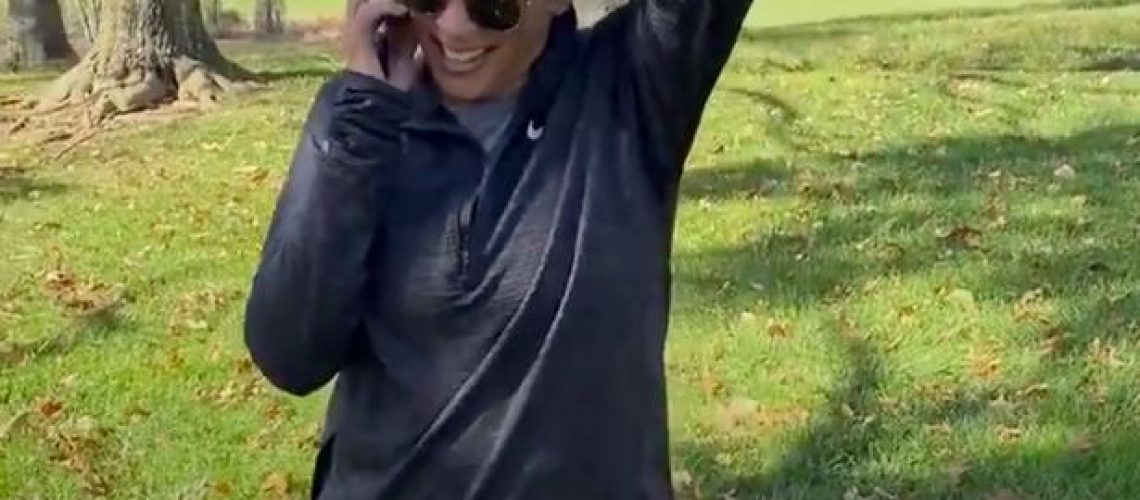 [Image description: Picture of Kamala Harris on the phone wearing sunglasses and a gray sweatshirt. Underneath is the caption: 